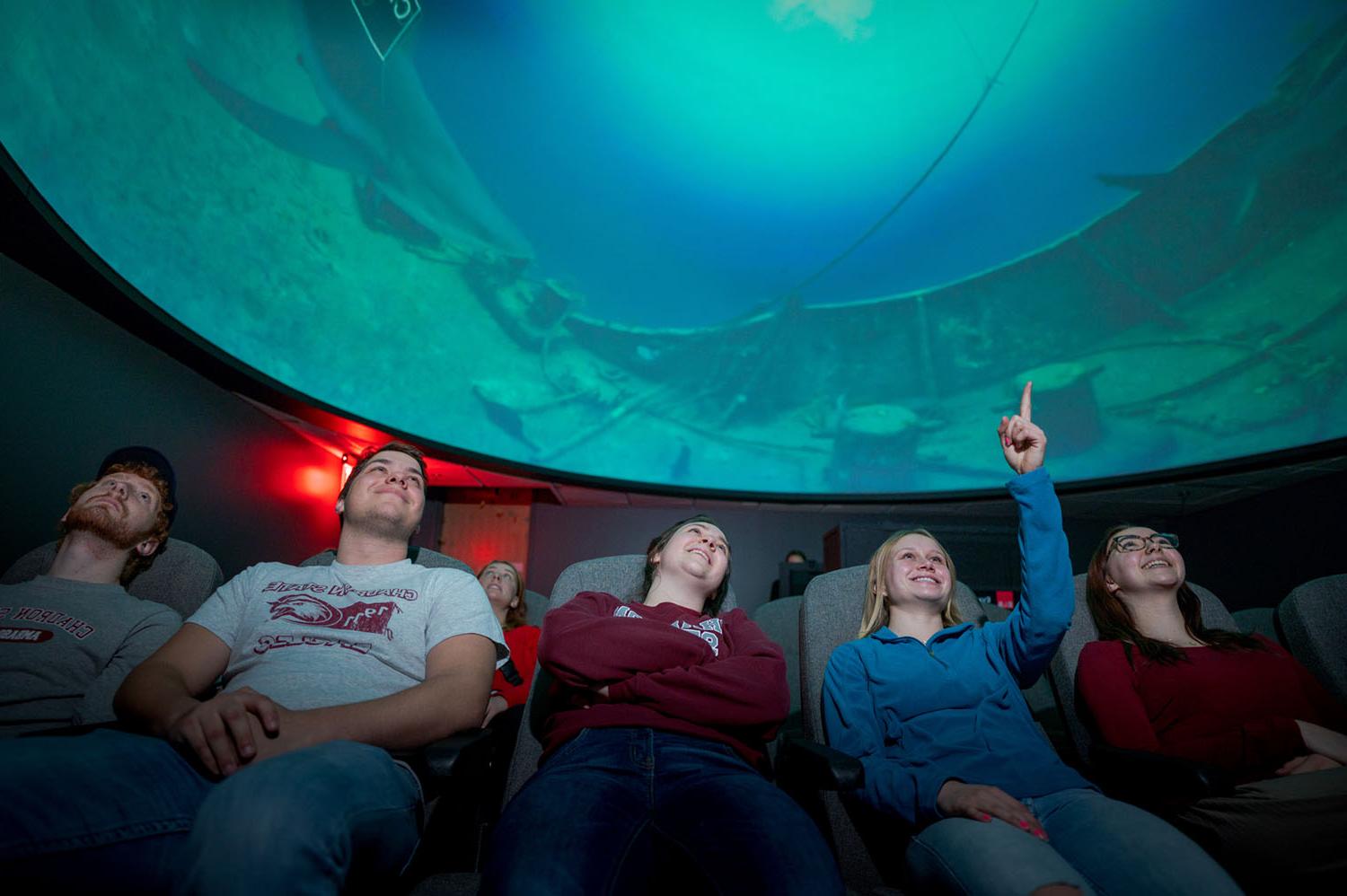Students watch a show in the planetarium